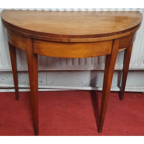 834 - A Georgian Mahogany bow fronted fold over Tea Table of simple form with square tapered supports.  D ... 