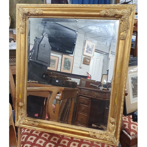 861 - A modern rectangular bevelled edge Mirror with carved details. 72 x 62 cm approx.