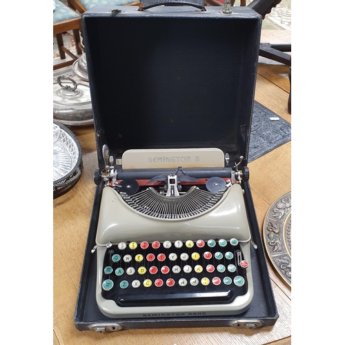 1098 - A vintage Remington Typewriter along with two Oriental Plaques.