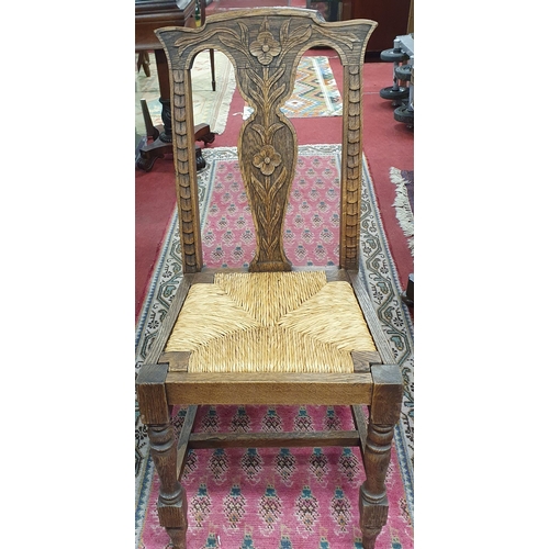 1101 - An early 20th Century Oak Hall Chair with rush seat. W 45 x SH 48 x BH 97 cm approx.