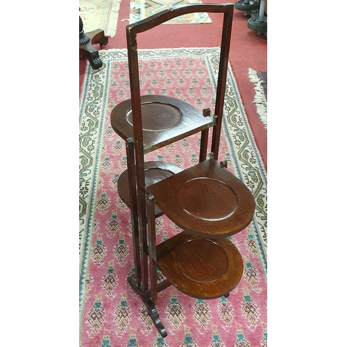 1111 - An Edwardian Mahogany Foldup Cake Stand. H 85 cm approx.