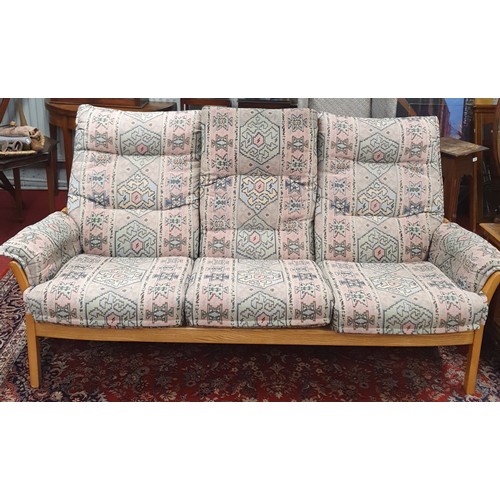 1127 - A good Ercol three seater Sofa along with an armchair and a pouffe. W 180 cm approx.