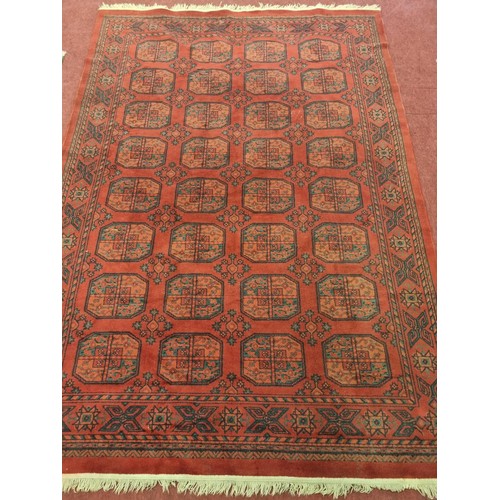 298 - A really good red ground Carpet with a unique repeating medallion design. 285 x 193 cm approx.