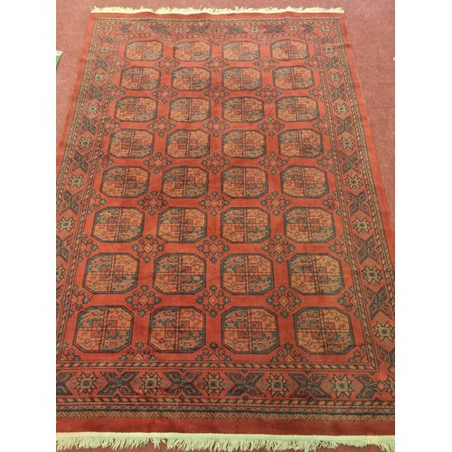 298 - A really good red ground Carpet with a unique repeating medallion design. 285 x 193 cm approx.