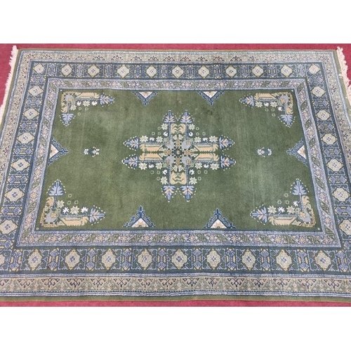 294 - A good green ground Rug with multi borders and central medallion design. 235 x 170 cm approx.