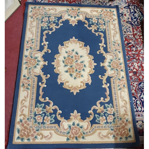 204 - A blue ground Rug with floral design. 120 x 170 cm approx.