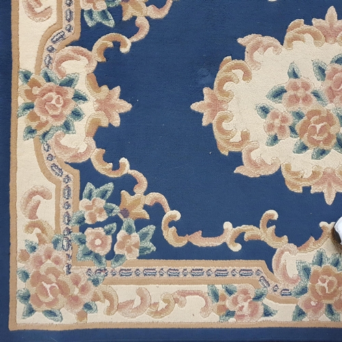 204 - A blue ground Rug with floral design. 120 x 170 cm approx.