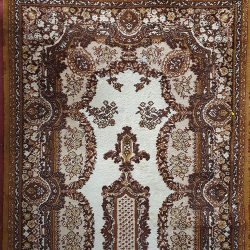 273 - A brown and cream ground Rug with multi borders and allover decoration. 180 x 91 cm approx.