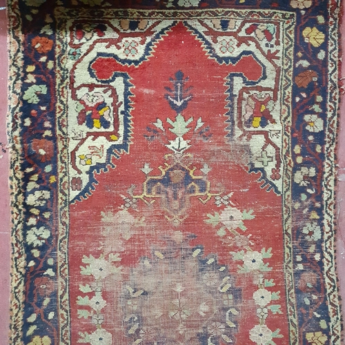 435 - A well worn Persian Rug. 110 x 210 cm approx.