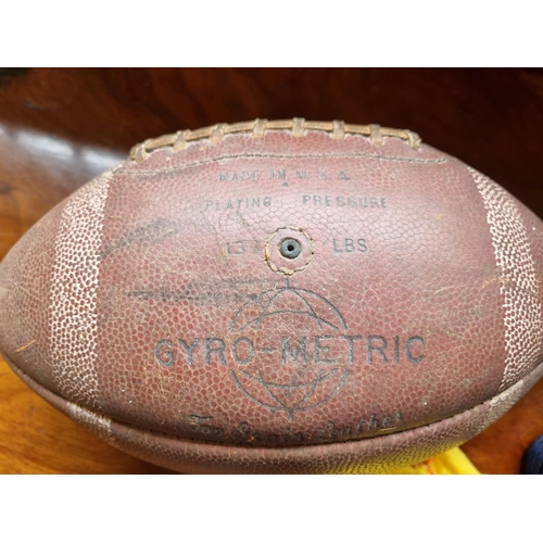 370 - A Vintage American Football, a set of Boules along with three coloured Prints.