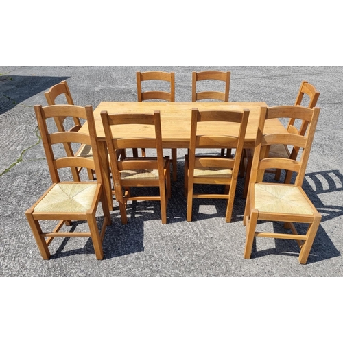 559 - A good modern solid Oak kitchen Table and eight Chairs. #