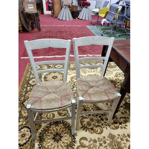 325 - A good set of 19th Century provincial kitchen chairs with rush seats.