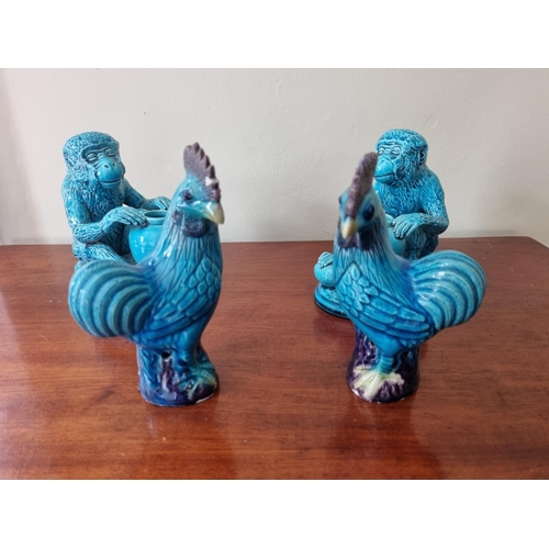 111 - A pair of Burmantofts Faience Monkeys along with a pair of Cockerels. H 14 & 15 cm approx.