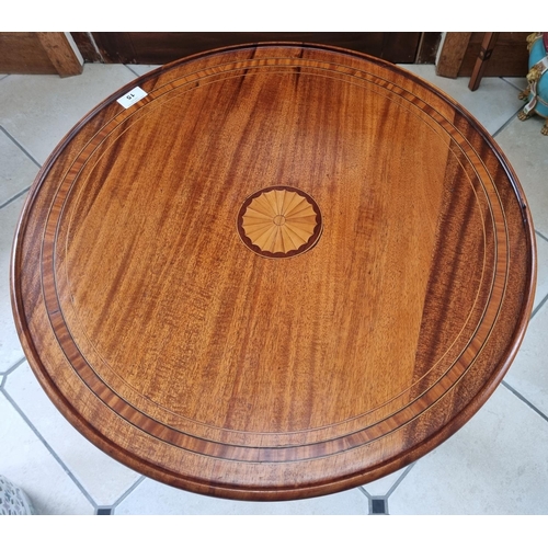 15 - An Edwardian Mahogany and Inlaid circular Supper Table with a shell inlay top, on turned tripod supp... 