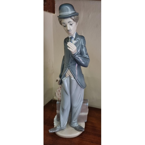 90 - A Lladro figure of Charlie Chaplin. H 28 cm approx.