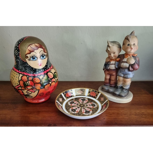 91 - An early Goebel figural group along with a Crown Derby pin dish and a group of Babushka dolls. H 14 ... 