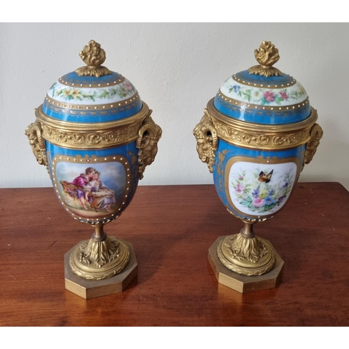 99 - A really good pair of 19th Century hand painted Urns with lids with ormolu rams head sides on plinth... 