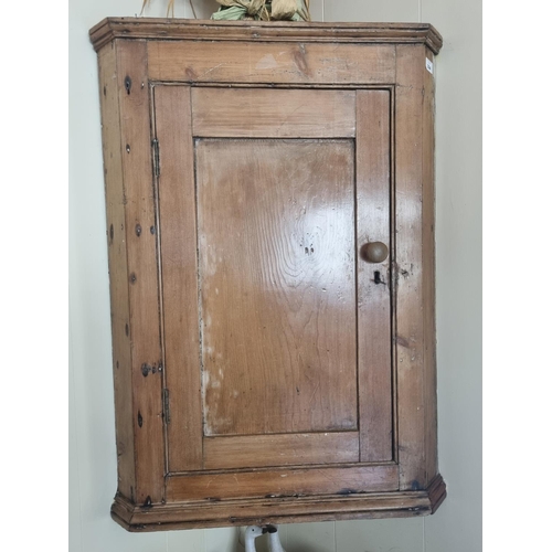 324 - A 19th Century wall mounted stripped and waxed Pine Corner Cabinet.  W 65 x H 90 cm approx.