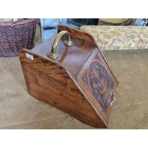 132 - A late 19th Century Walnut Coal scuttle with highly carved flap and brass fittings. W 33 x 47 x H 33... 