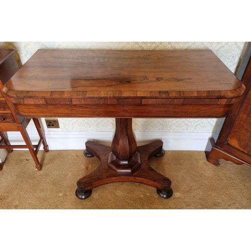 146 - An early 19th Century Rosewood Foldover Card Table on hexagonal shaft platform base and turned suppo... 