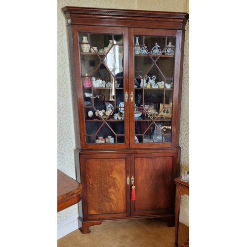 152 - A 19th Century Mahogany Corner Cabinet with twin astragal glazed upper doors, a twin panelled base o... 