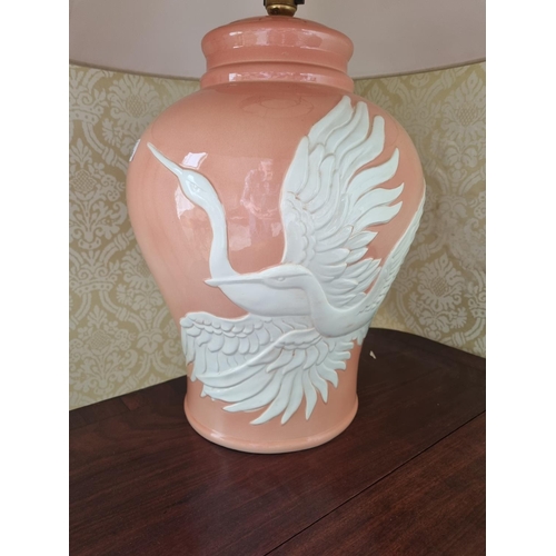 196 - An Italian made large bulbous pink ground Table Lamp depicting a pair of swans in full flight.
H 42 ... 