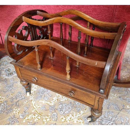 222 - A 19th Century Rosewood three division Canterbury on turned supports and brass castors, with single ... 