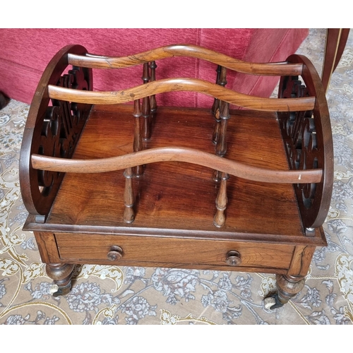 222 - A 19th Century Rosewood three division Canterbury on turned supports and brass castors, with single ... 