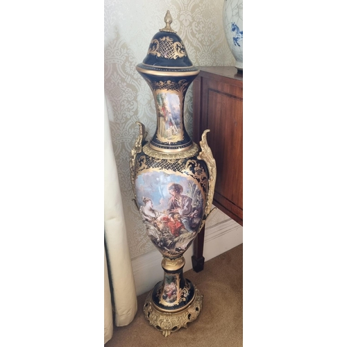 227 - A very large pair of Urns with lids profusely decorated in hand painted decoration with Ormolu mount... 