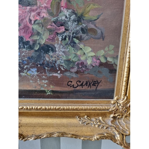 230 - An early 20th Century Oil on Canvas still life of flowers in a vase on a table setting. Signed C San... 