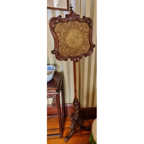 270 - An early 19th Century Mahogany Pole Screen with barley twist turned support and highly carved tripod... 