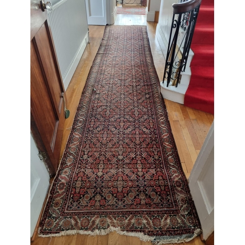 312 - A very long Vintage Iranian Runner with red ground, multi borders and allover repeating medallion ce... 