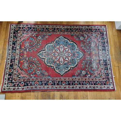 313 - A red ground Persian village Rug from the Surok region with multi borders and central medallion desi... 