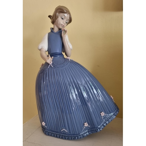 357 - A large Lladro Figure of a young girl in a blue dress. H 28 cm approx.