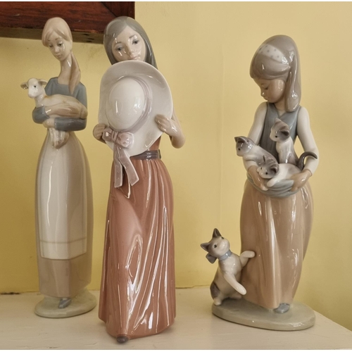 360 - A Lladro Figure of a young Girl holding a kitten along with another Lladro figure of a girl holding ... 