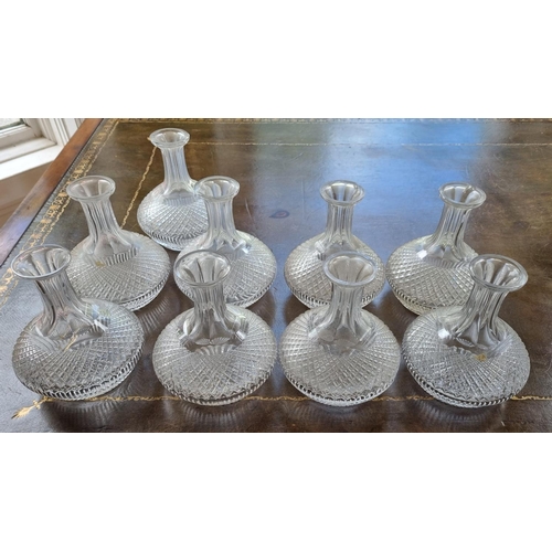 376 - A set of nine early Waterford half Carafes. (some with nibbles).