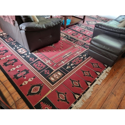 390 - A red ground modern Carpet with Aztec style design. 240 x 340 cm approx.