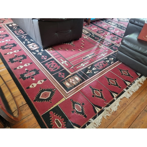 391 - A red ground modern Carpet with Aztec style design. 240 x 340 cm approx.