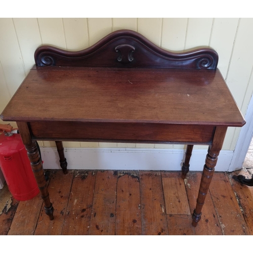 765 - A late 19th Century Mahogany Side Table of narrow proportions, on turned supports and gallery back. ... 