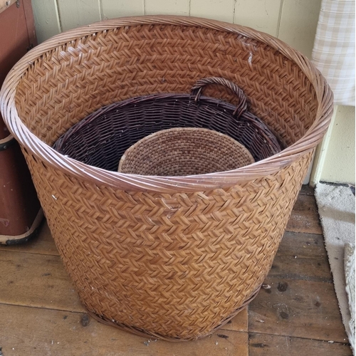 815 - A large Wicker log Basket and two others. D64 x L 53cm approx.