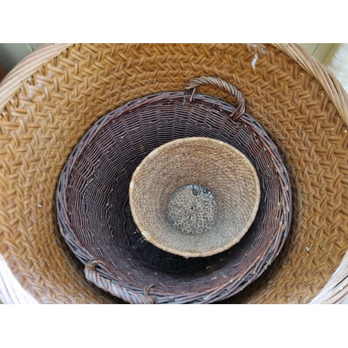 815 - A large Wicker log Basket and two others. D64 x L 53cm approx.