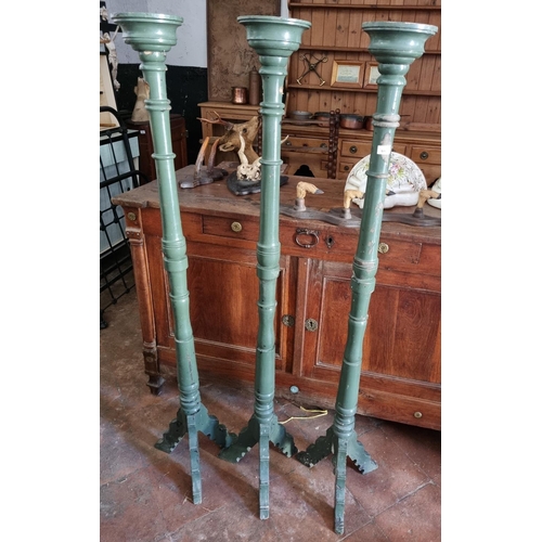 918 - A set of three painted Torchiere/Candle Stands on tripod bases. H 152 cm approx.