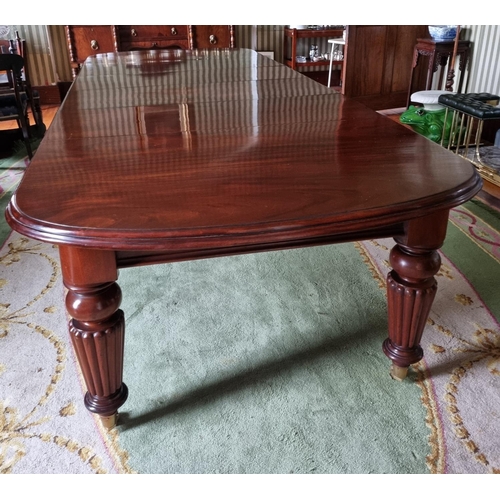 252 - A magnificent 19th Century Dining Table on substantial turned and reeded supports and moulded edge w... 