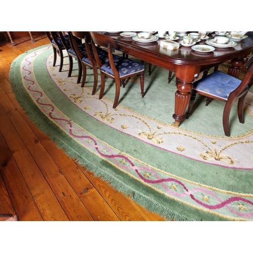 292 - A Fantastic oval green ground Donegal Carpet with multi borders and swagged interior.
570 x 338 cm a... 