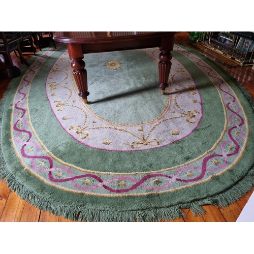 292 - A Fantastic oval green ground Donegal Carpet with multi borders and swagged interior.
570 x 338 cm a... 