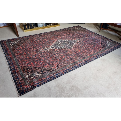 74 - A Wool pile Persian Kashan Carpet with Terracotta and rich Blue ground from the Shahrukh region. 300... 