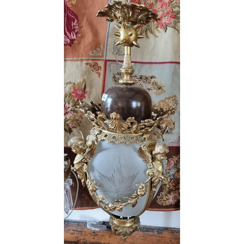 760 - A really good Brass hall Lantern profusely embossed with Cherubs with a cloudy glass shade. W 40 x H... 