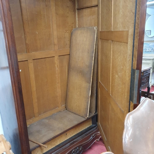 399 - A 19th Century Rosewood and Veneered single door Armoire with highly carved outline and bevelled mir... 