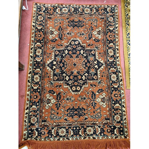 318 - A rust ground Rug with multi borders and allover decoration. 134 x 89 cm approx.