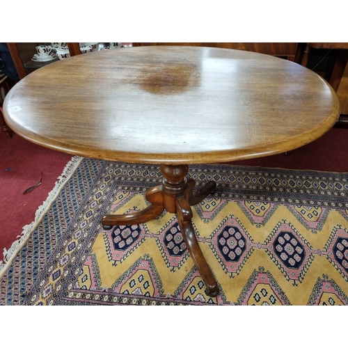 393 - A 19th Century Mahogany Oval Supper Table on tripod supports. H 77 x 105 x 84 cm approx.